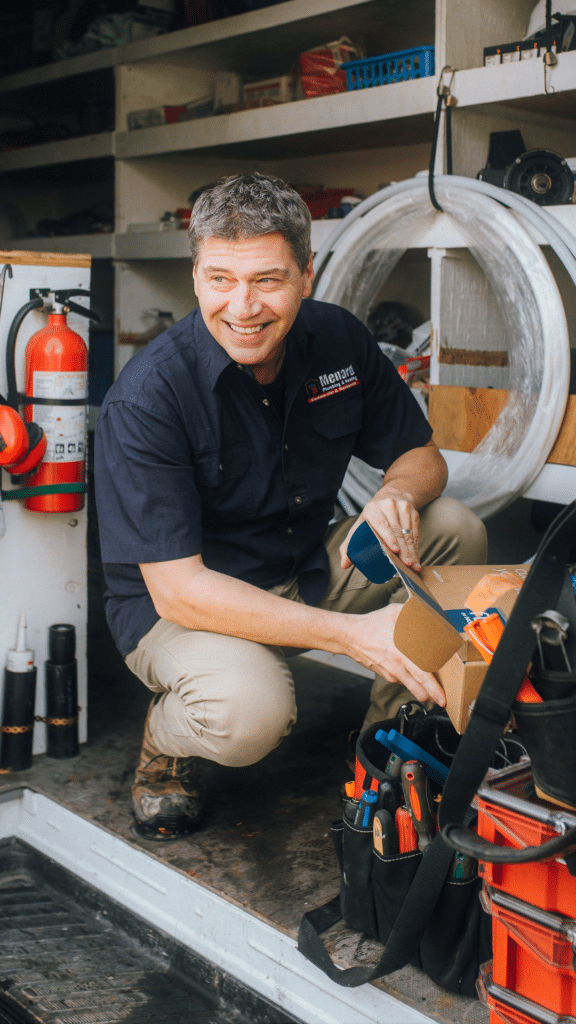Owner of plumbing company smiling on a job because of his plumbing marketing campaign.